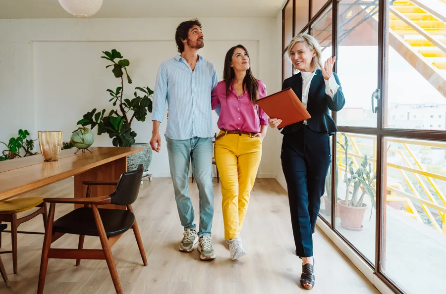 Agent showing a bright home to prospective buyers